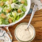 creamy caesar salad dressing in jar with spoon