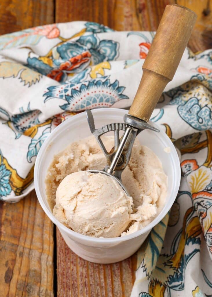 quick and easy cinnamon spice ice cream in container with wooden scoop