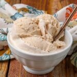 philadelphia style ice cream with cinnamon in white bowl with gold spoon