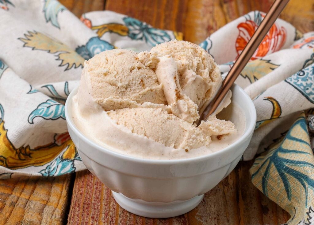 philadelphia style ice cream with cinnamon in white bowl with gold spoon