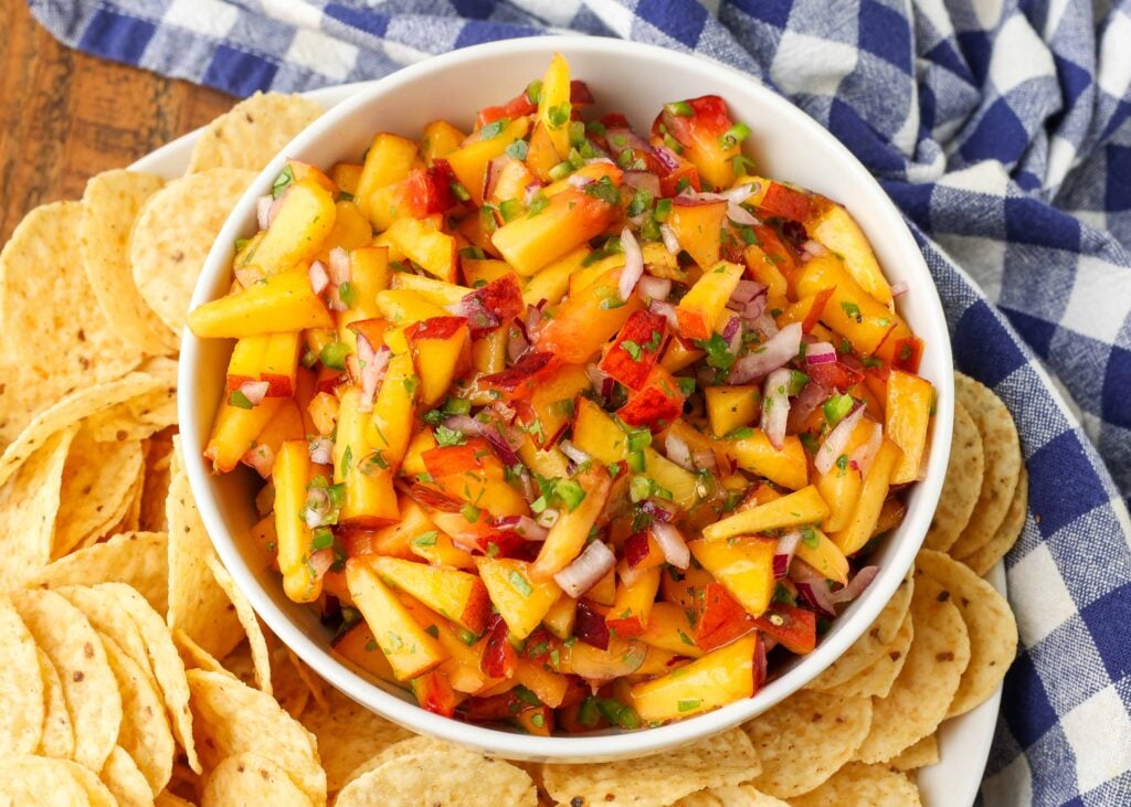 overhead photo of fruit salsa in bowl surrounded by chips