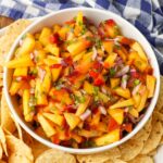 overhead photo of fruit salsa in bowl surrounded by chips