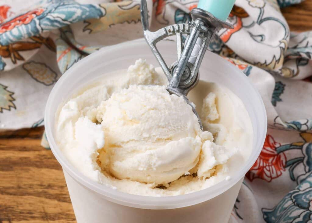 close up of ice cream in scoop in container 
