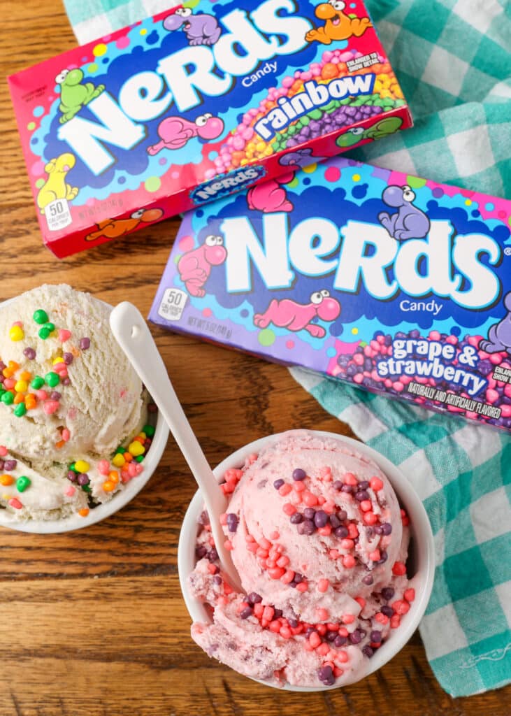 bowls of pink and white ice cream on wooden table