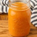 asian salad dressing in a mason jar with a striped linen