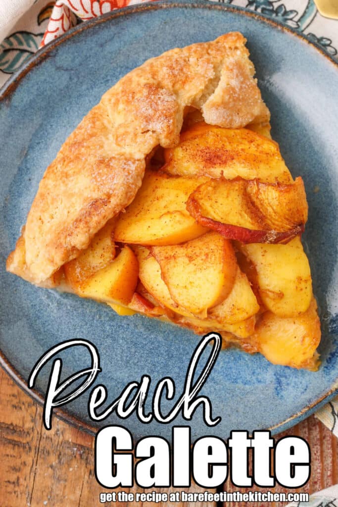 rustic style galette filled with peaches on blue plate with gold fork