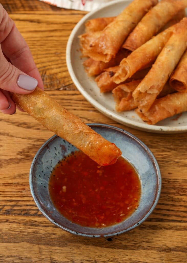 lumpia with dipping sauce on table