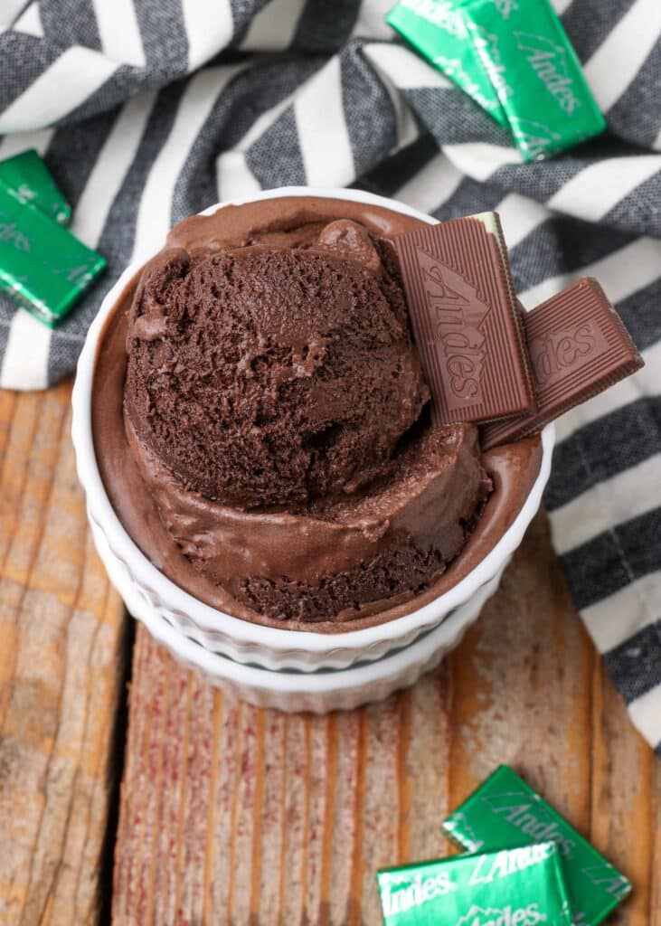 chocolate ice cream with chopped up Andes mints on wooden table in white dish