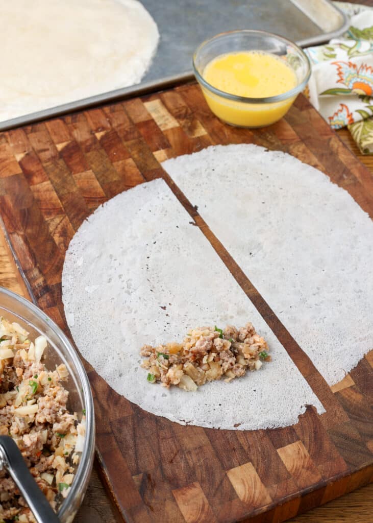 rolling lumpia on cutting board