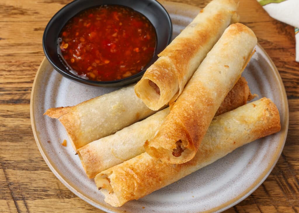 air fried lumpia on small plate with dipping sauce 