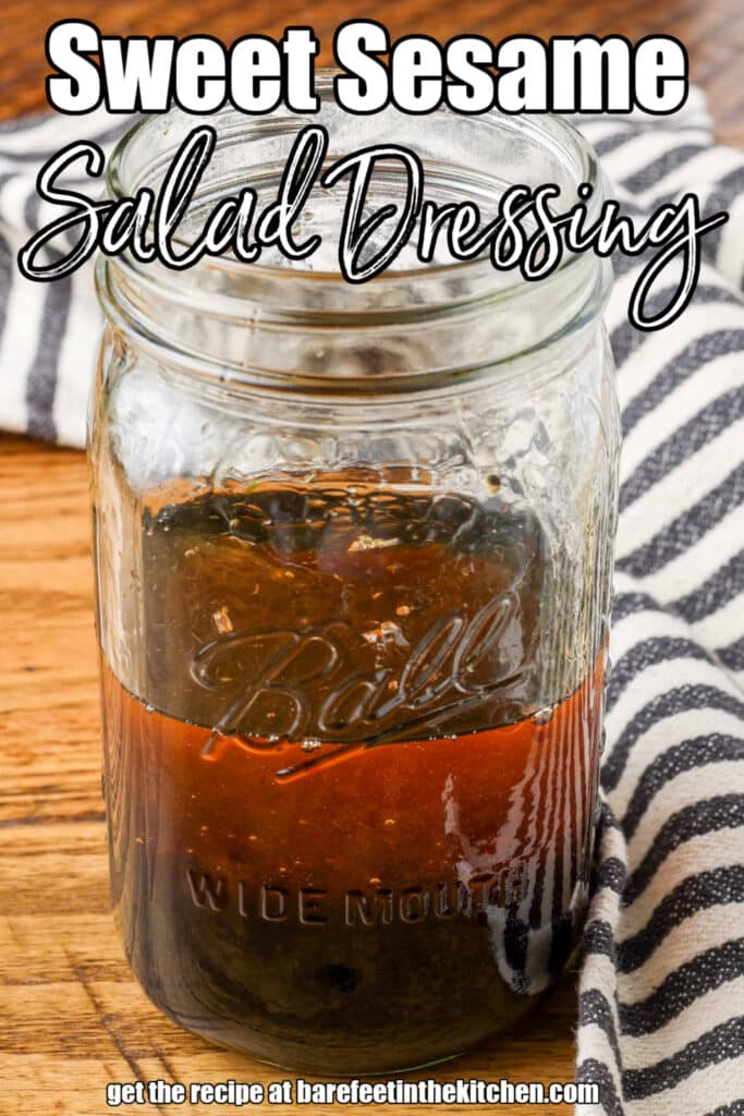 mason jar of sweet sesame dressing on a wooden surface with a striped linen with text overlay describing photo