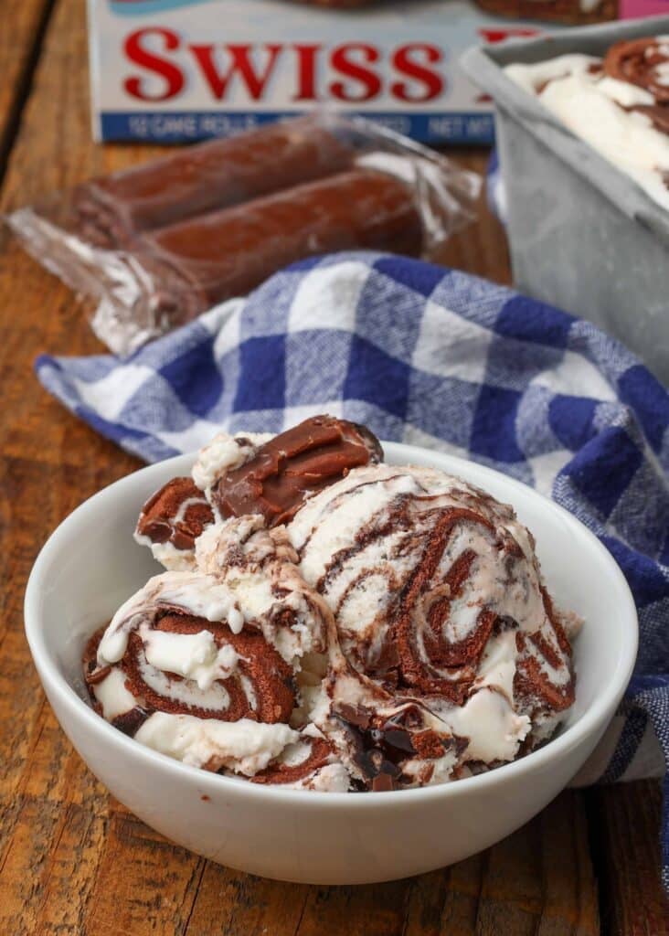 swiss rolls with ice cream on wooden table