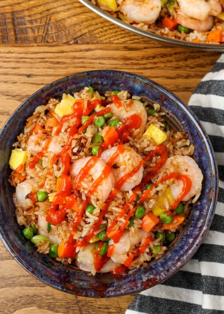overhead photo of shrimp fried rice in blue pottery bowl
