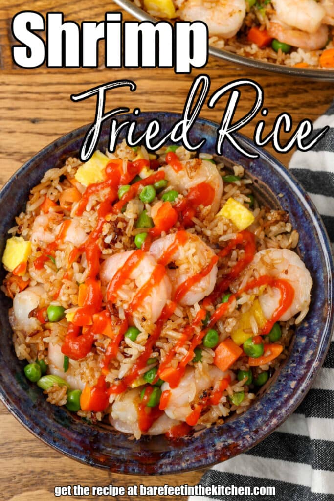 close up of fried rice with Sriracha drizzled over it
