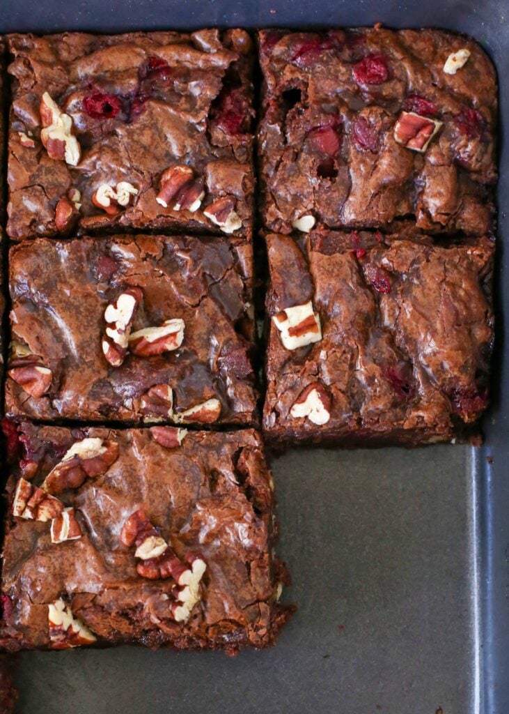 brownies with pecans and cranberries sliced in baking pan