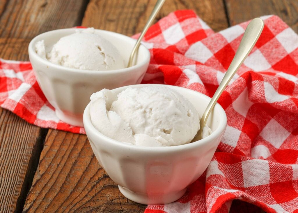 ice cream made with coconut milk in little white bowl next to red napkin