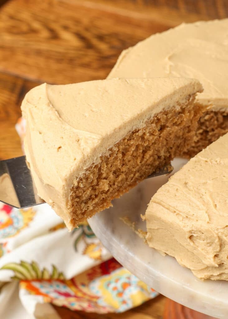 coffee cake with coffee frosting on a plate with a spatula