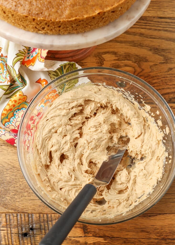coffee frosting in a bowl with an offset spatula