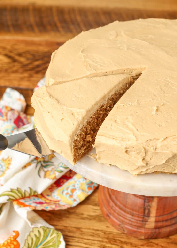 coffee cake with coffee frosting on a plate with a spatula