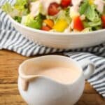 russian dressing in a salad dressing boat with a spout and a salad