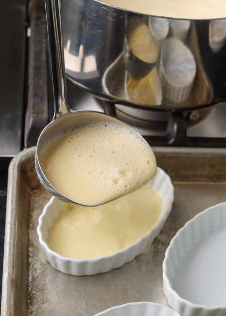 Creme brulee in a ramekin on a sheet pan.