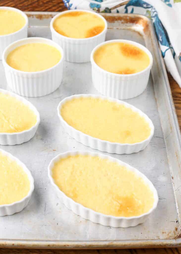 Creme brulee in a ramekin on a sheet pan.