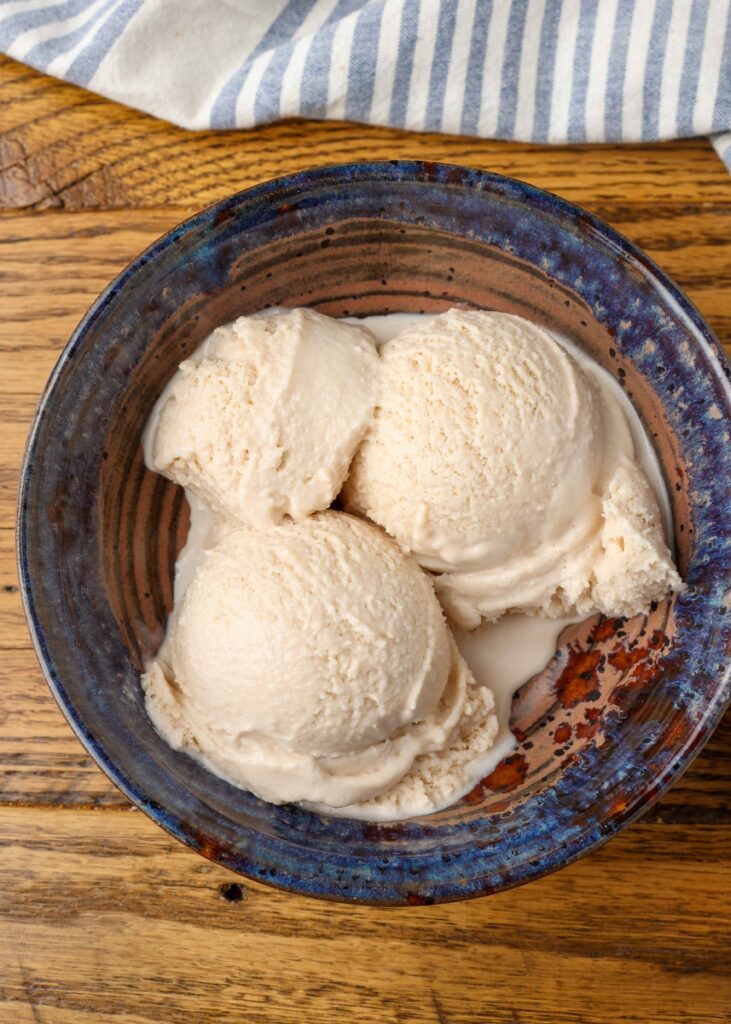 Homemade Bailey's ice cream in a blue pottery bowl with a blue and white striped linen