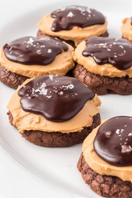 A brownie cookie topped with peanut butter and chocolate ganache.
