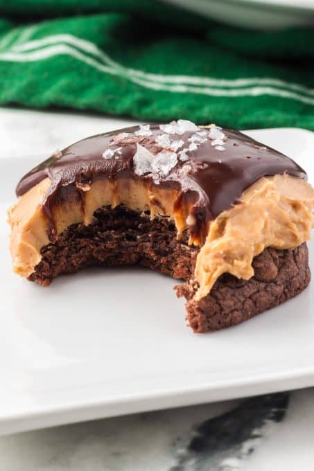 A bite taken out of a chocolate peanut butter cookie.