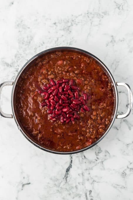 Kidney beans added to a pan of homemade chili.