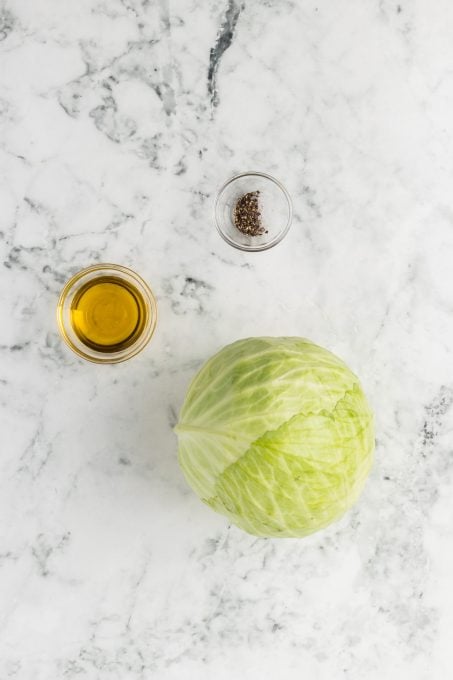 A head of cabbage, olive oil, salt, and pepper.
