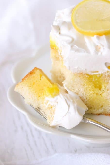 A bite of Lemon Marshmallow Poke Cake.