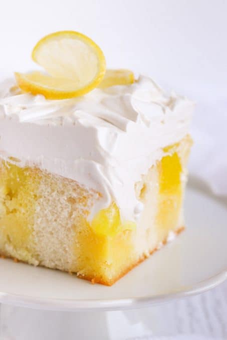 Lemon Poke Cake with lemon gelatin, lemon pie filling and marshmallow frosting.