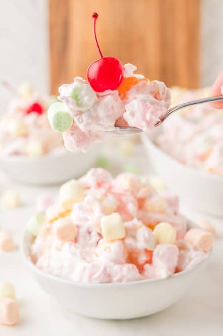 A bite of a Southern creamy fruit salad.