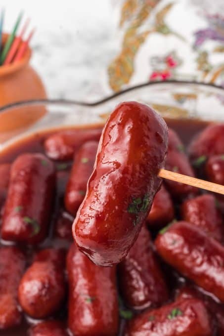 A cocktail sausage on a toothpick.