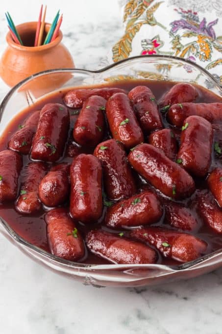 Crockpot Lil Smokies in a bowl with toothpicks and a napkin.