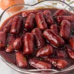 Crockpot Lil Smokies in a bowl with toothpicks and a napkin.