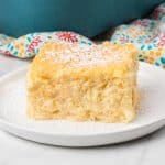 A plated slice of an Italian Easter dessert in front of a blue pan and napkin.