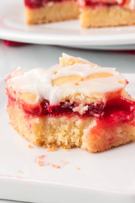 A bite taken out of pie bars glazed pie bars.