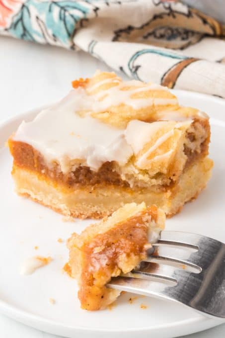 A bit taken out of pie bars made with a spiced pumpkin filling.