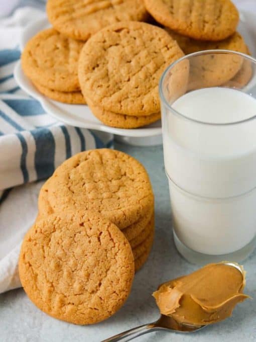 Peanut Butter Cookies made with just 3 ingredients, a glass of milk, and a spoonful of peanut butter.
