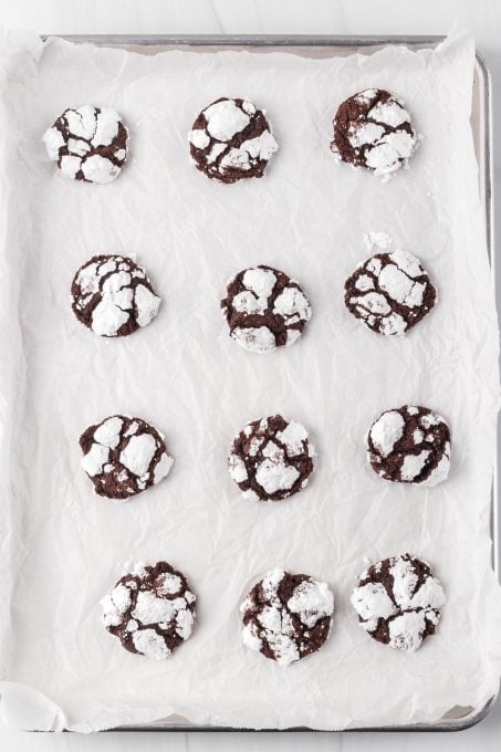 A tray of baked chocolate cookie crinkles.