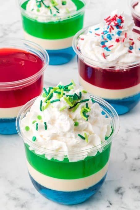Whipped cream and sprinkles on jello desserts.