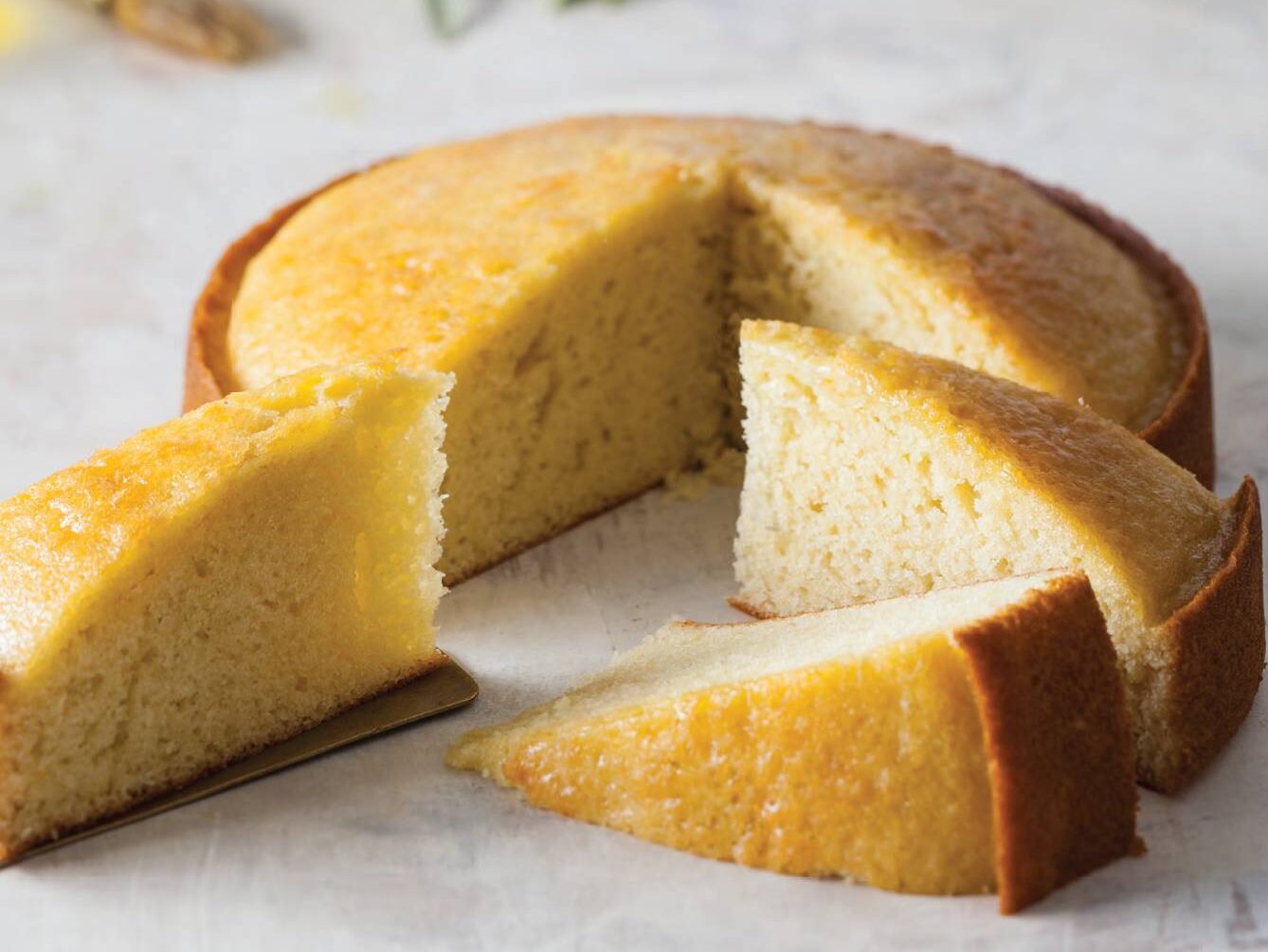 classic olive oil cake sliced on cream surface