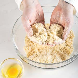 Mixing sablee dough with hands