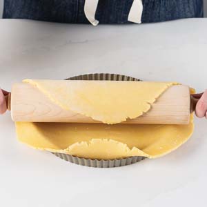 Rolling dough in pie dish
