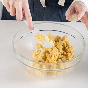 Mixing sablee dough with spatula