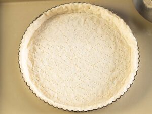 Crust in tart pan ready to be baked
