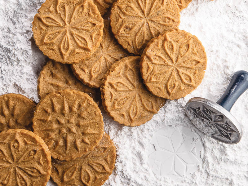 Pressed Speculaas on a bed of powdered sugar.