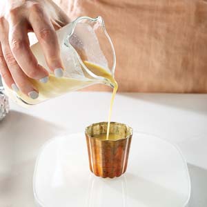 Pouring batter in canele molds